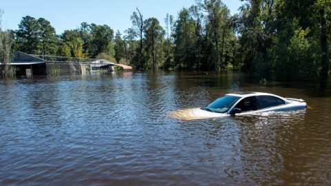 Image of car in flood waters.