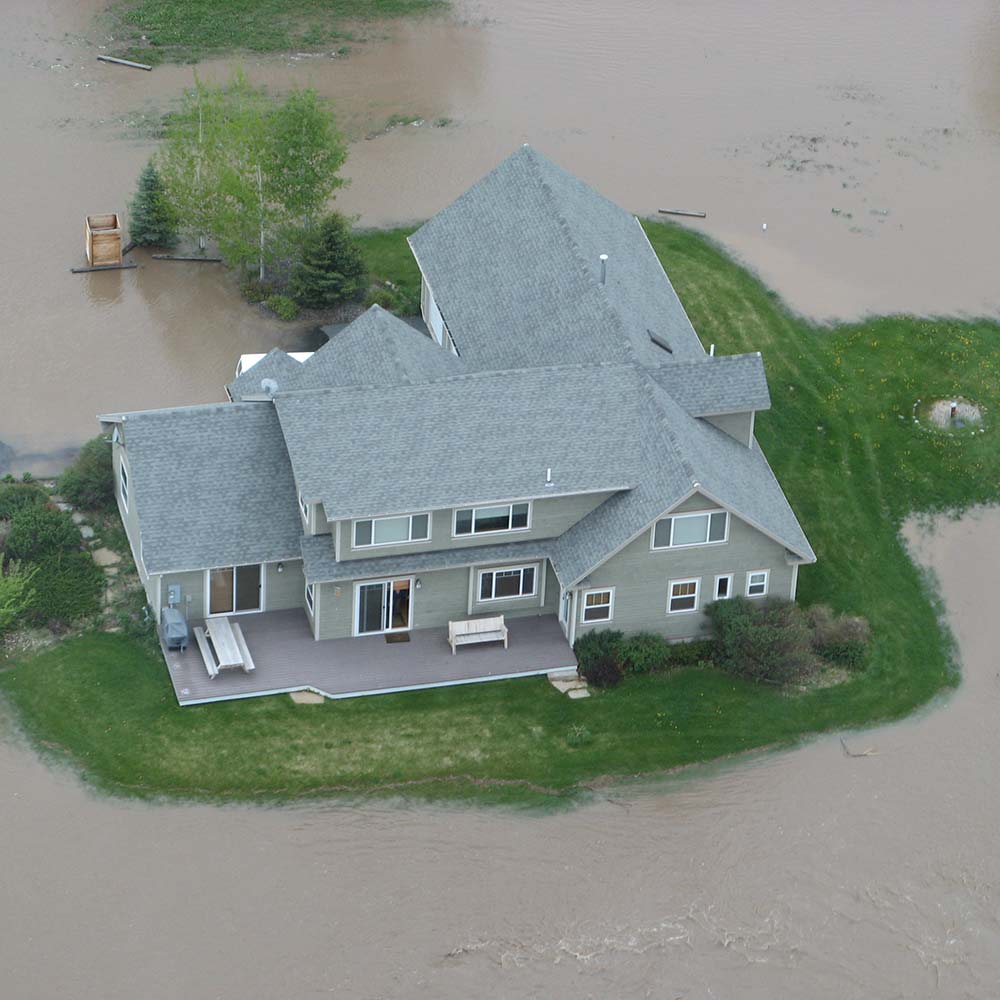 house surrounded by flood water